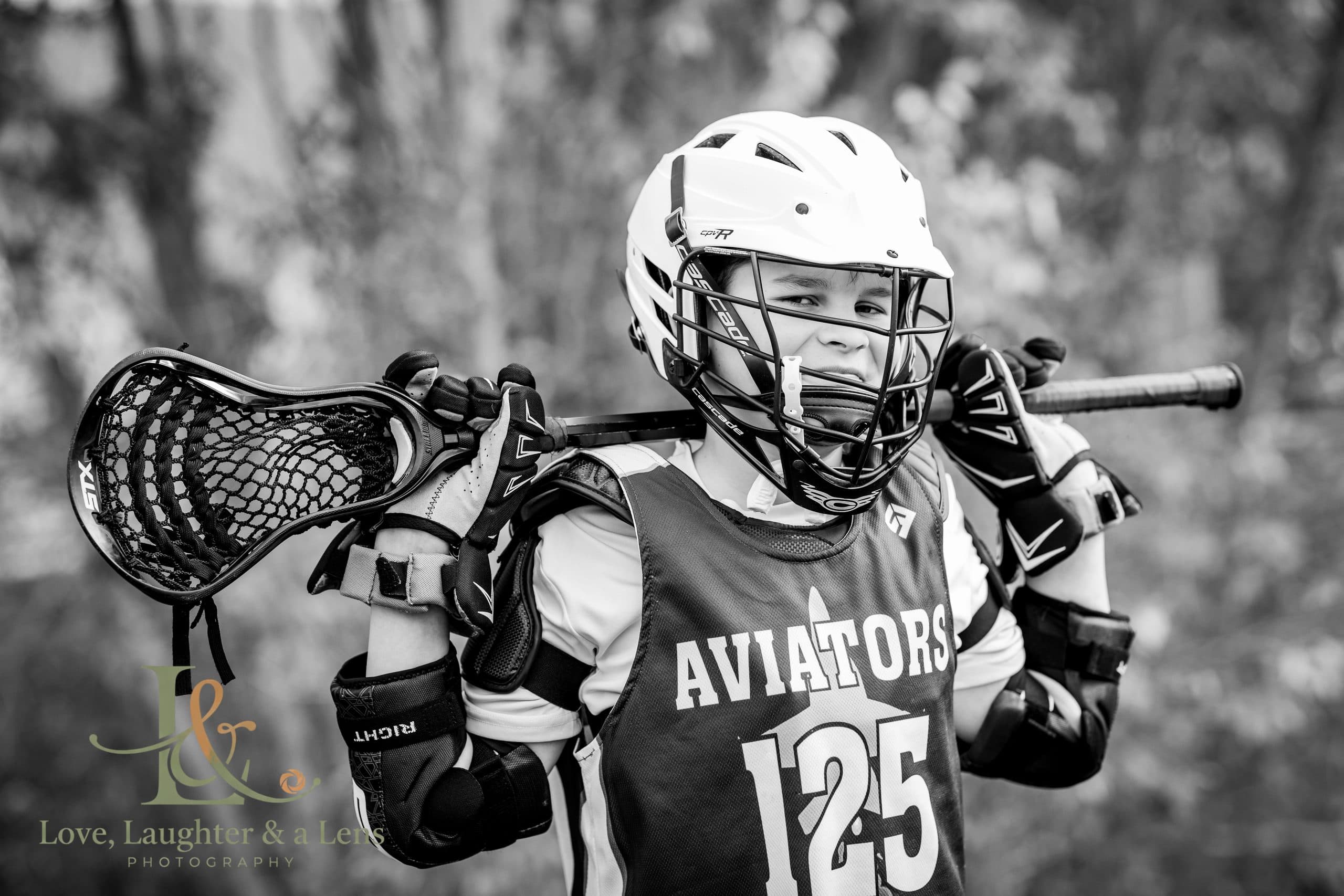 Black-and-white portrait of a young lacrosse player
