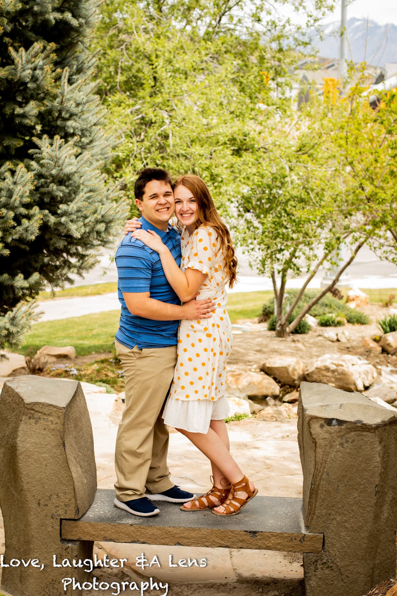 Couple hugging on stone steps in a park