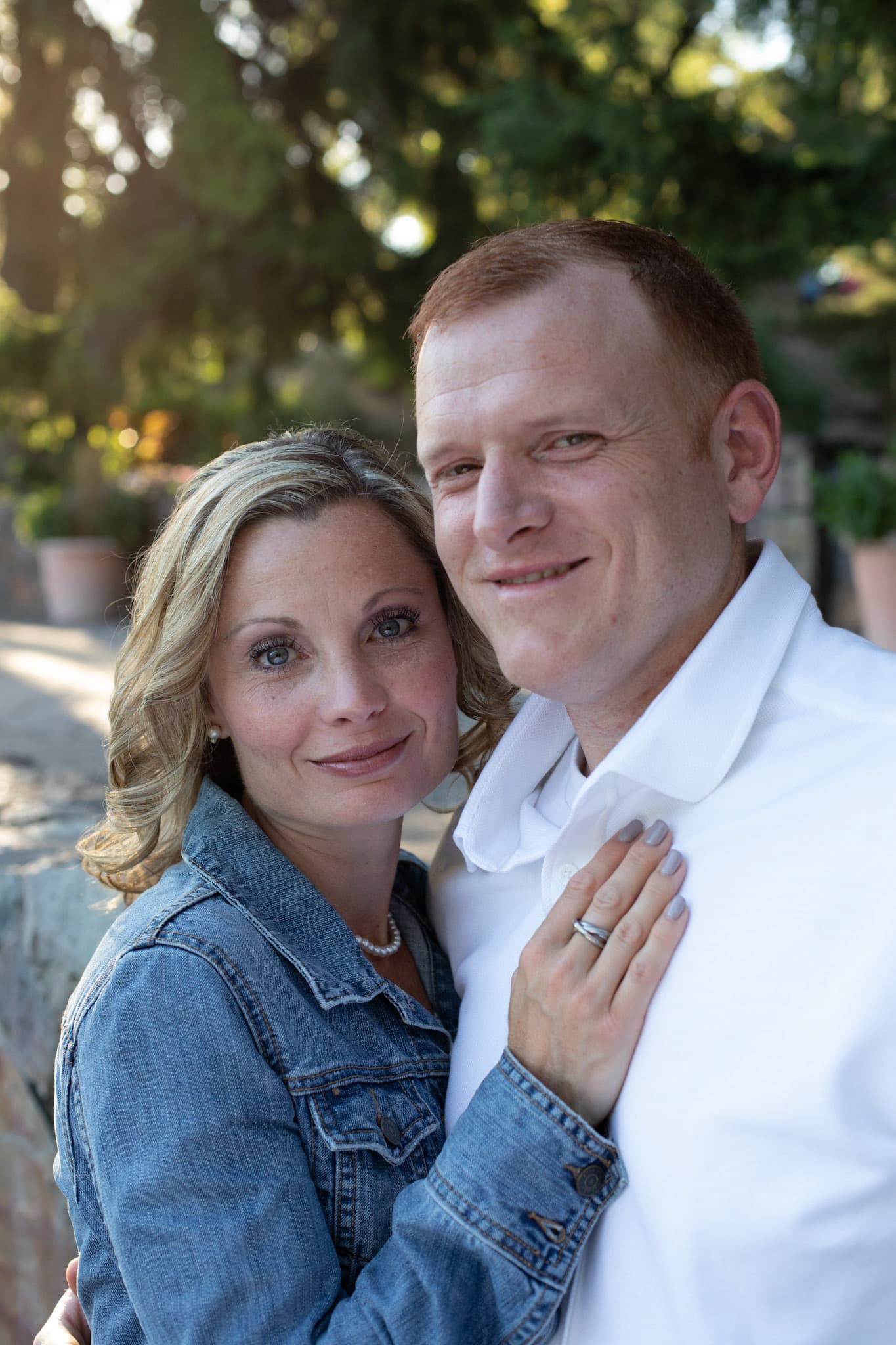 Couple in denim and white smiling outdoors