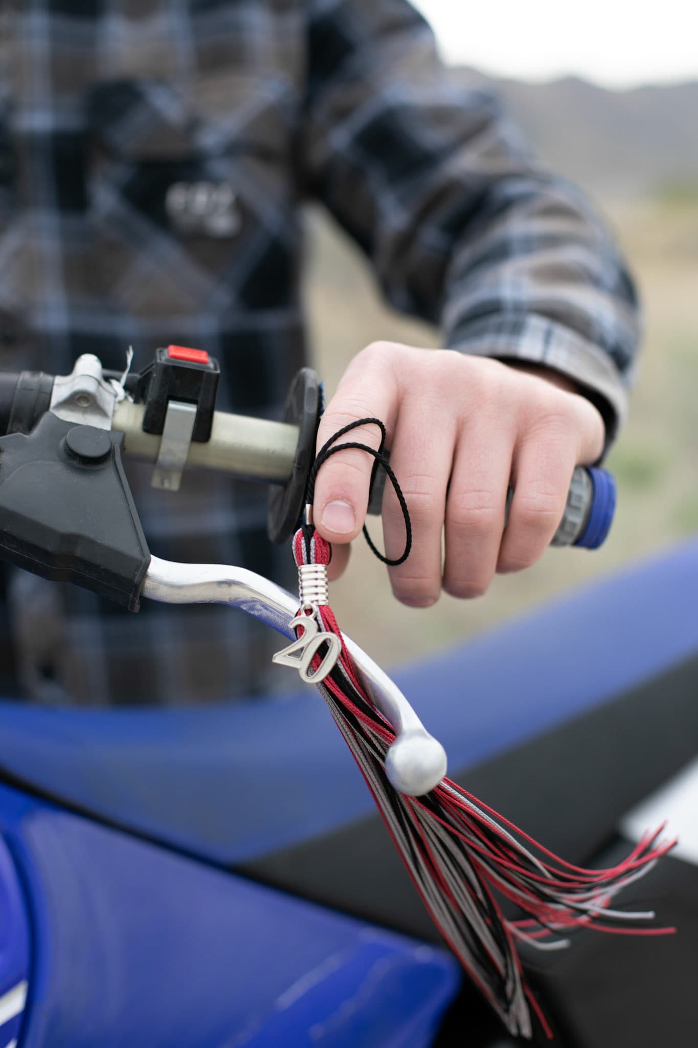 Graduation tassel hanging from a dirt bike handlebar