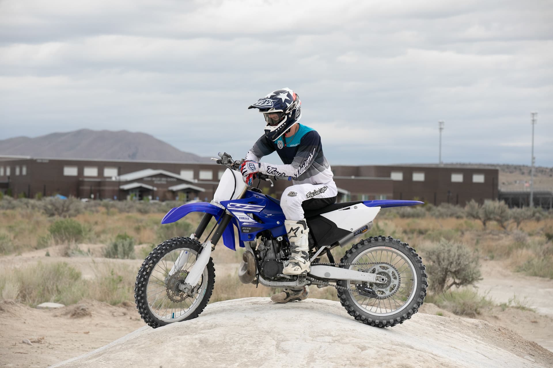 Senior in motocross gear on a dirt bike