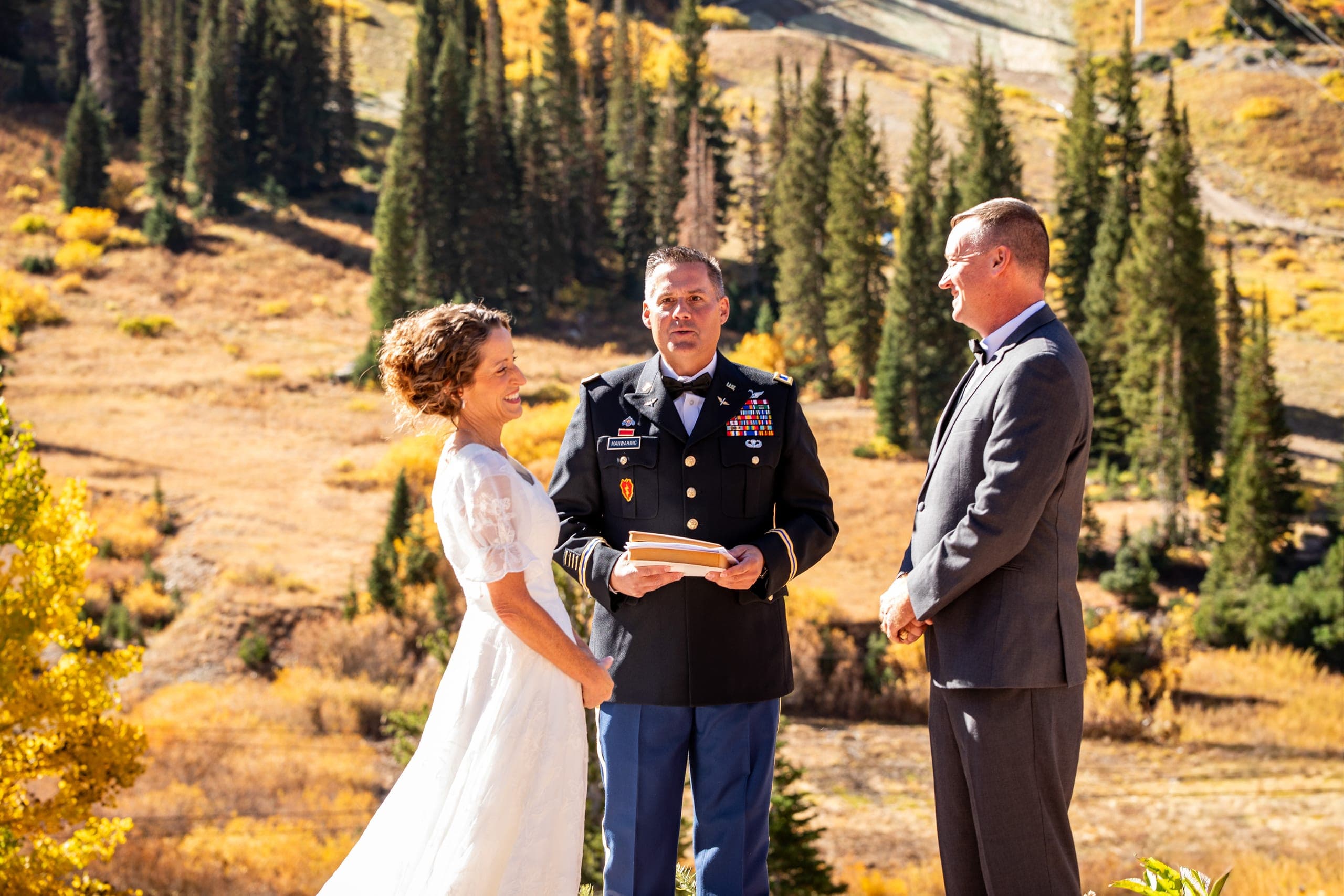 Mountain wedding ceremony among pine trees