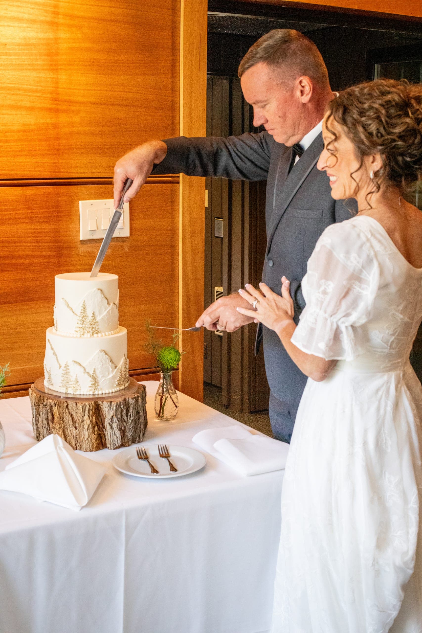 Bride and groom cutting their wedding cake